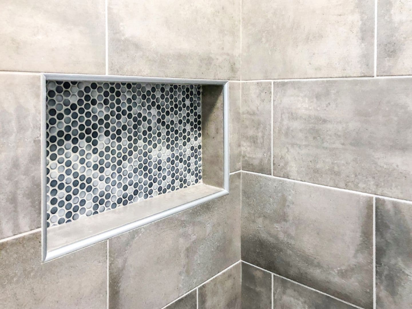 A recessed wall niche in a shower.