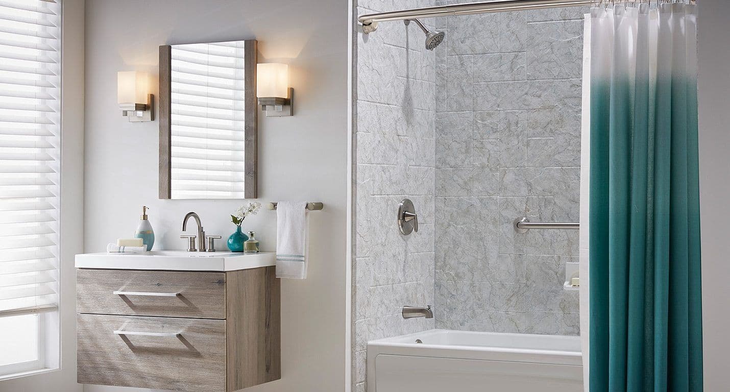 A combination shower tub with a BathWraps Venture Breccia finish.